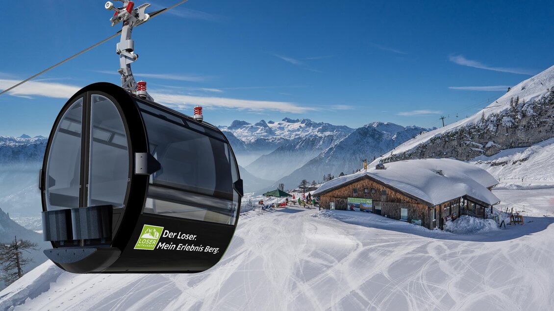 <p><p>Die Gondel der Panoramabahn der Loser Bergbahnen fährt über die verschneite Berglandschaft in Altaussee. Im Hintergrund ist die das Restaurant auf der Loseralm zu sehen.</p></p> | © Porsche Design Studio