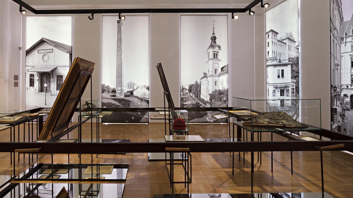 Ein Ausstellungsraum mit historischen Bildern und Skulpturen. Glasvitrinen zeigen verschiedene Exponate in einem modernen Ambiente. | © c_Graz_Museum- Wolfgang_Thaler