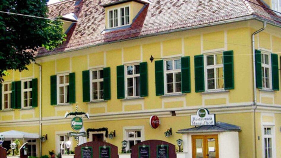 Gemütliches Restaurant Brandhof mit gelber Fassade in Graz. | © Brandhof