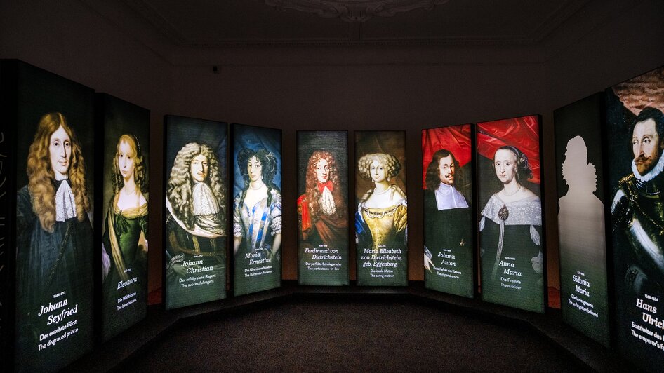 Digitale Porträts von historischen Personen in einer Ausstellung.